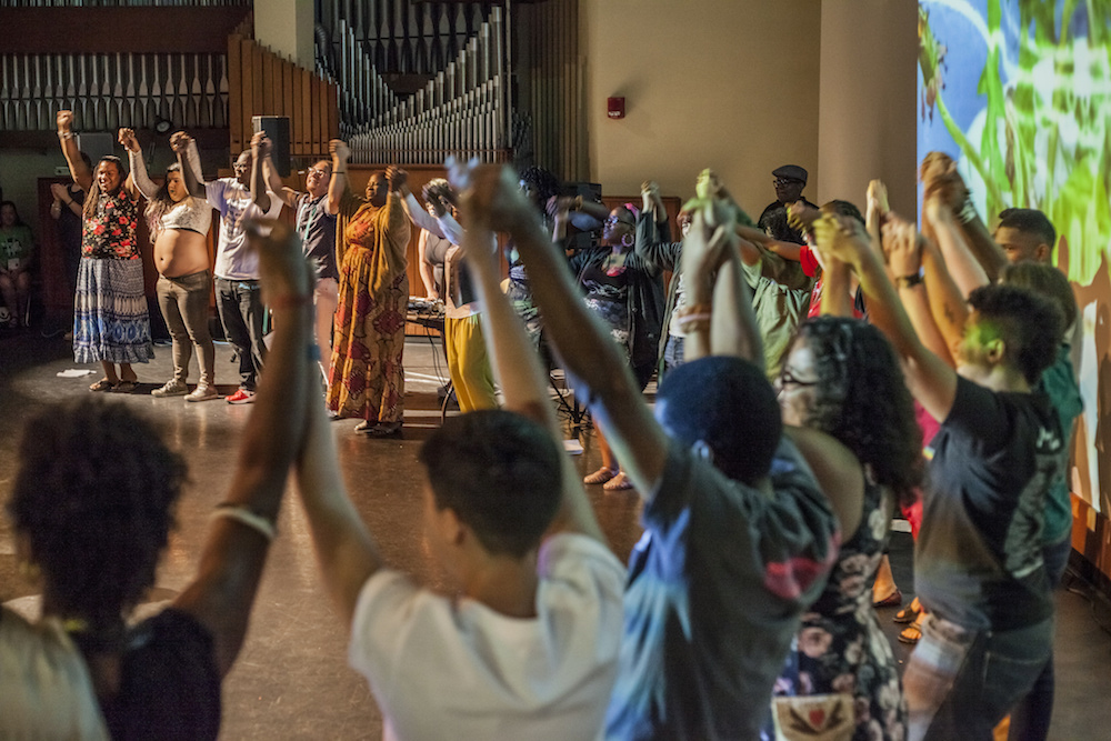 Participants of Get Ready Stay Ready holding raised hands together in a circle