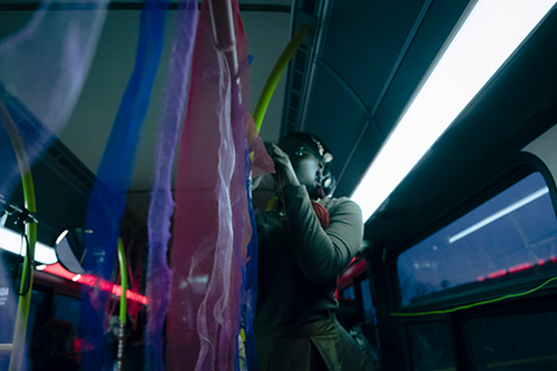 Still from Riding With Aunt D. Dot of a person standing on a DDOT bus