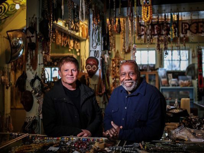 Lorcan O’Herlihy and Olayami Dabls standing amongst beads in the Mabls Mbad African Bead Museum
