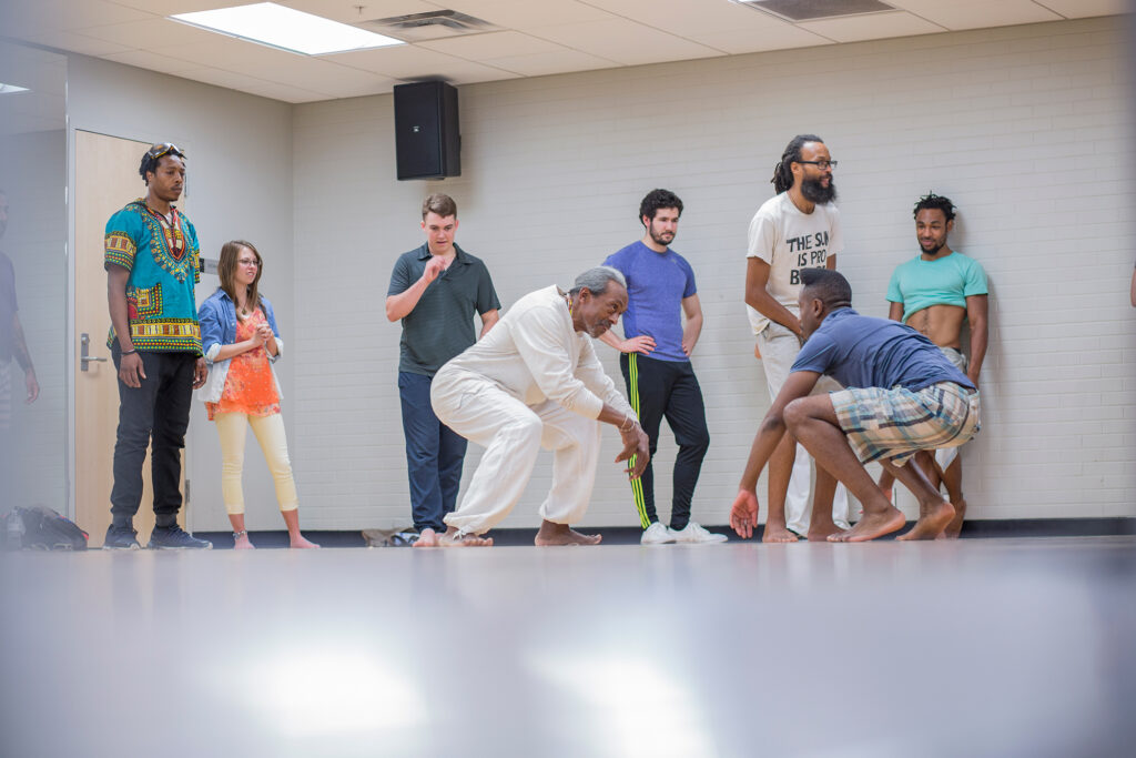 People engaged in mirrored movement in an AMC practice space