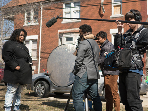 Production shot from Take Me Home with the crew filming an actor